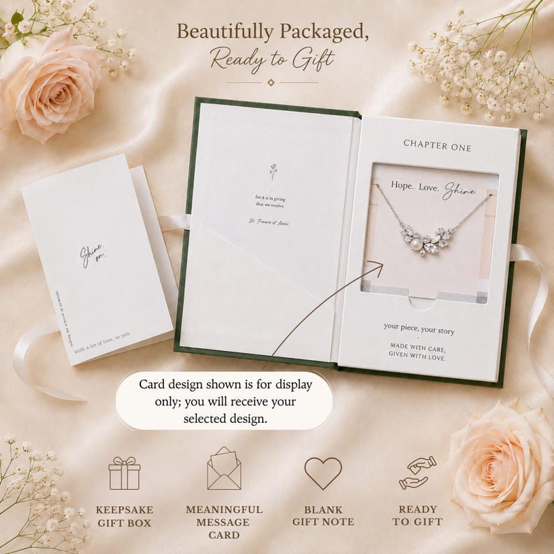 May include: A white gift box with a silver necklace, a card that says "Shine", and a blank card. The box is open, revealing a necklace with a floral design. Text on the box reads "Hope. Love. Shine" and "Ready to Gift."