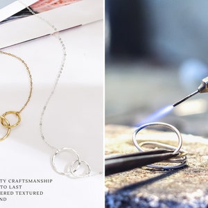 Gift your long-distance friend with our Unbiological Sisters Necklace. Crafted in 14k gold and sterling silver, and featuring eternity circles, it symbolizes your unbreakable bond. The necklace is 18 inches long with an adjustable ring at 16 inches.