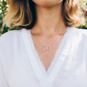 Honor your soul sister with our best friend necklace, a meaningful token of enduring friendship. Sterling silver designed with classic eternity circles symbolizes everlasting bonds. The Pendant measures 1 inch in width and 0.65 inches in height.