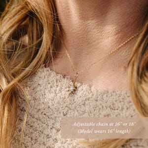 a close up of a person wearing a necklace