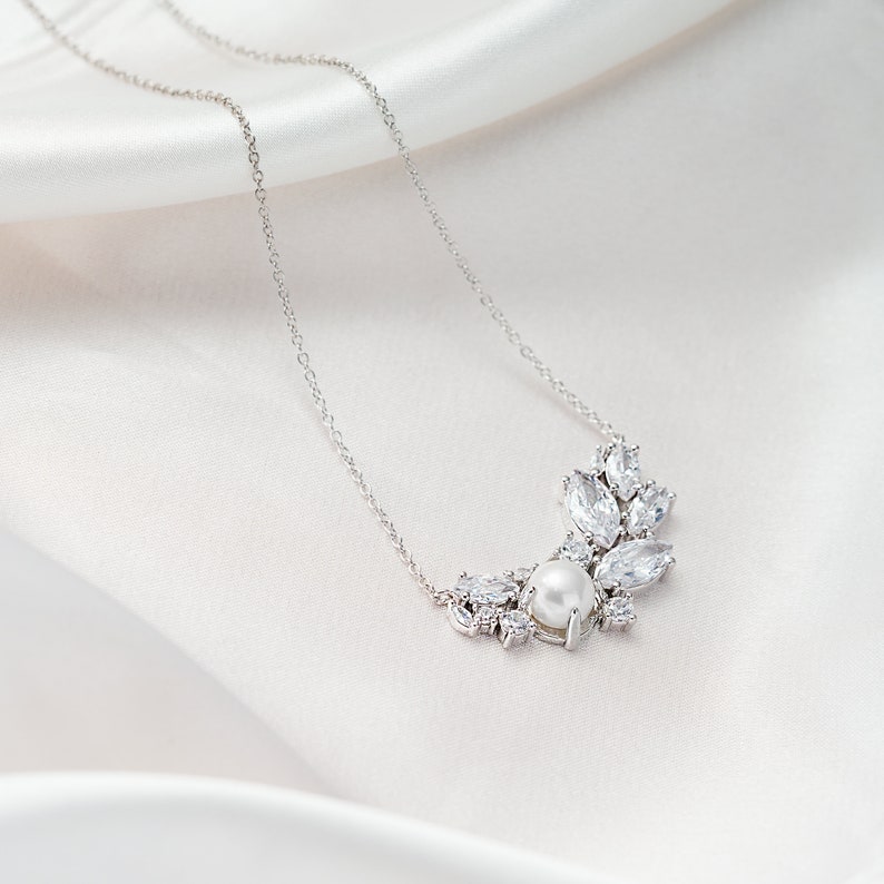 This exquisite sterling silver necklace combines the timeless elegance of a pearl with the brilliance of cubic zirconia. The 18 inch chain with an adjustable loop at 16 inches offers a personalized fit and a perfect Step Mom Wedding Gift.