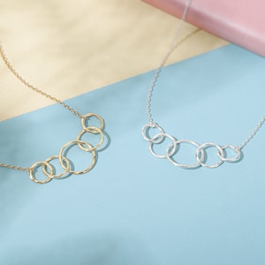 Crafted with sterling silver and 14k gold vermeil, our elegant 5-ring necklace radiates elegance and sophistication, making it a perfect 50th gift for her. This necklace is 18 inches long with an adjustable ring at 16 inches for a perfect fit.