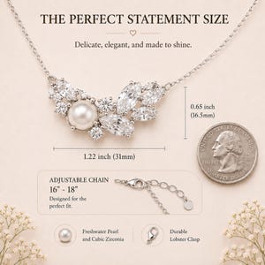 May include: A silver necklace with a cluster of clear cubic zirconia and a central freshwater pearl. The necklace is 1.22 inches (31mm) wide and has an adjustable chain from 16 to 18 inches. The text reads "THE PERFECT STATEMENT SIZE".