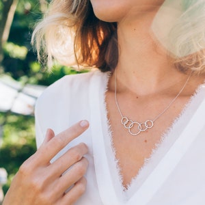 Mark her 50th birthday with our exquisite 5-ring necklace, crafted with care from sterling silver. Symbolizing five decades of love and laughter, this meaningful piece is a heartfelt gift she will treasure for many years to come.