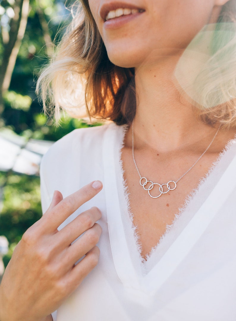 Mark her 50th birthday with our exquisite 5-ring necklace, crafted with care from sterling silver. Symbolizing five decades of love and laughter, this meaningful piece is a heartfelt gift she will treasure for many years to come.