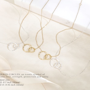 Say goodbye with our sentimental farewell gift, a beautiful reminder of cherished memories shared. This 14k gold and sterling silver necklace features two linked circles, an iconic symbol of infinite love, strength, protection, and unity.