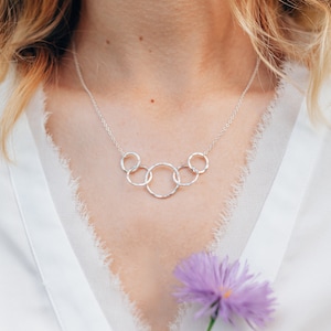 Wish her a happy 50th birthday with our exquisite interlocking circle necklace, crafted with care from sterling silver. This timeless piece is a beautiful representation of her journey and the love she has shared throughout the decades.