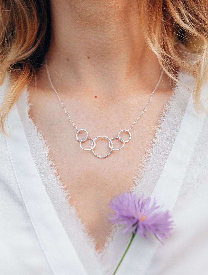 Wish her a happy 50th birthday with our exquisite interlocking circle necklace, crafted with care from sterling silver. This timeless piece is a beautiful representation of her journey and the love she has shared throughout the decades.