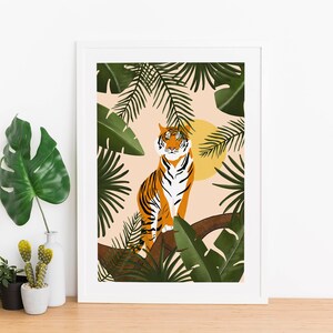 May include: A framed illustration of a tiger sitting in a tree with green leaves and a yellow sun behind it. The background is a light peach color.