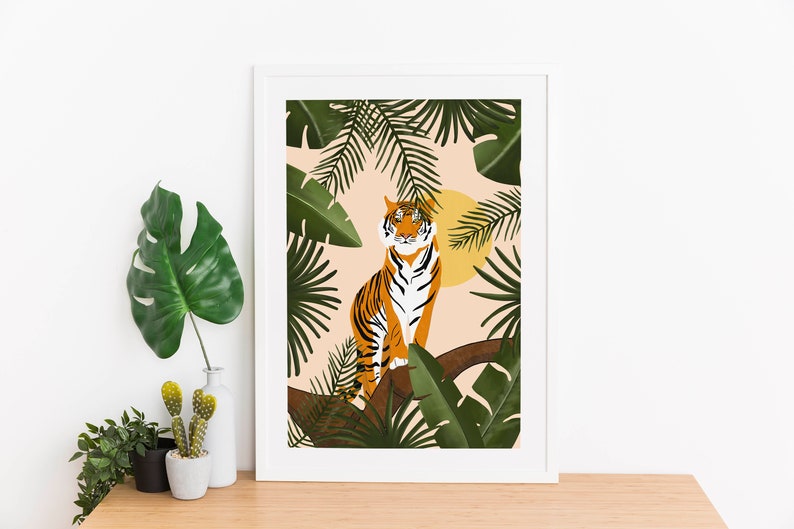 May include: A framed illustration of a tiger sitting in a tree with green leaves and a yellow sun behind it. The background is a light peach color.