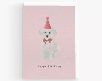 May include: A pink birthday card with a white dog wearing a pink party hat and a red bow tie. The card says "happy birthday".