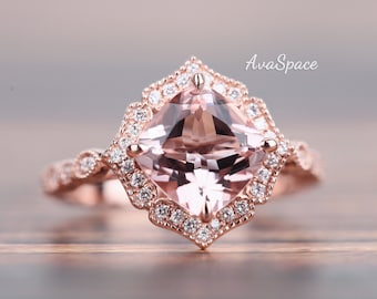May include: A rose gold engagement ring with a large square-shaped morganite center stone surrounded by a halo of smaller diamonds. The band is also set with smaller diamonds.