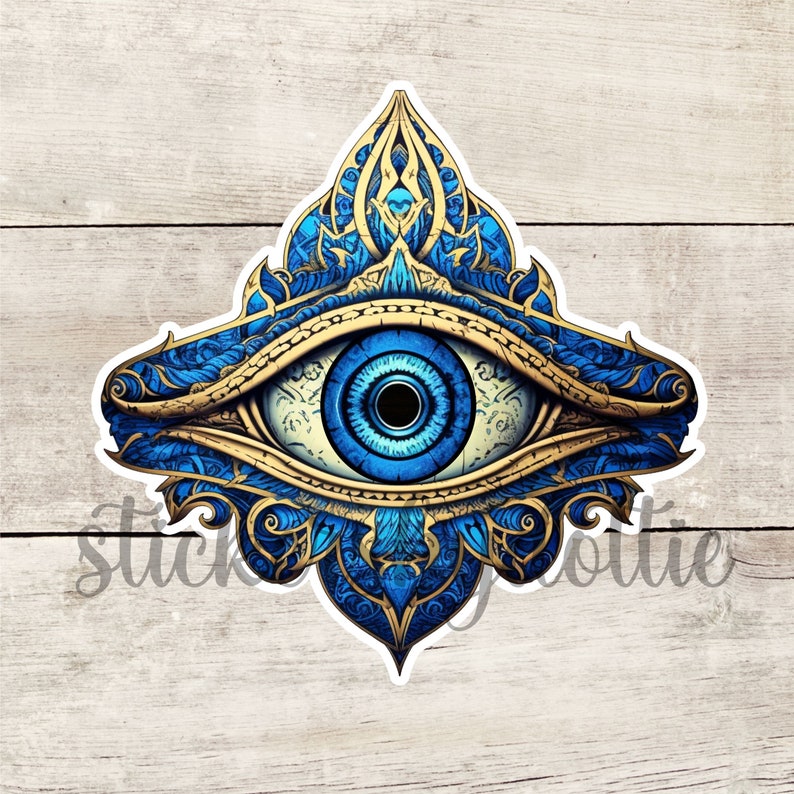 May include: A blue and gold evil eye with intricate floral patterns. The eye is surrounded by a golden frame and has a white pupil.