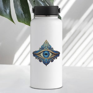 May include: White water bottle with a blue and gold eye design sticker. The eye is surrounded by intricate floral patterns.