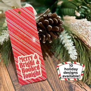 May include: A red and white striped gift tag with the words "Merry & Bright & Booked Tonight" in white. A smaller tag reads "10 holiday designs available!" The tag is decorated with glitter and is set against a festive background.