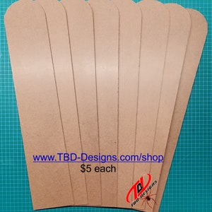 May include: Eight brown leather strips, each with a rounded top and bottom edge. The strips are arranged in a fan shape, with the text "www.TBD-Designs.com/shop" and "$5 each" visible at the bottom.