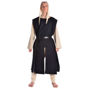 May include: A person wearing a long, dark blue tunic with a white hood and a leather belt. The tunic has a slit in the front and is sleeveless. The person is standing on a white background.