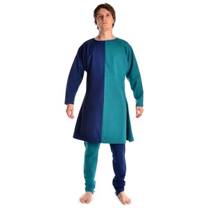 May include: A long-sleeved tunic with a blue and teal color block design. The tunic has a round neckline and a slightly flared hem.
