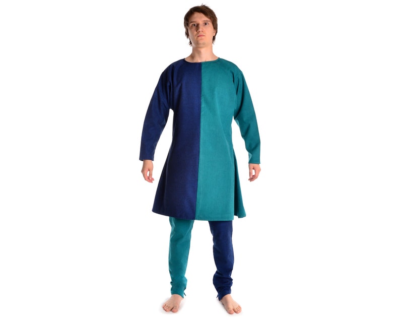 May include: A long-sleeved tunic with a blue and teal color block design. The tunic has a round neckline and a slightly flared hem.