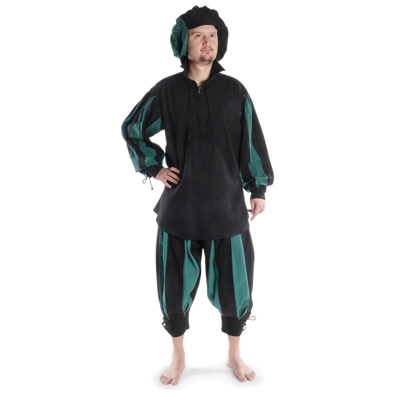 May include: A black and green striped shirt and pants costume. The shirt has a lace-up neckline and long sleeves. The pants are cuffed at the ankles. The person is wearing a black cap with a green brim.