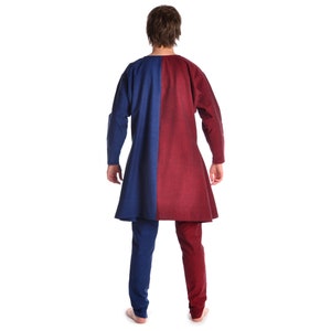 May include: A long-sleeved tunic with a blue and red color block design. The tunic has a long, flowing hem and is made of a soft, comfortable fabric.