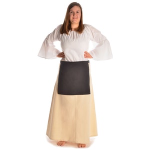 May include: A white peasant blouse with long sleeves and a black apron. The blouse has a gathered neckline and the apron has a simple rectangular shape.