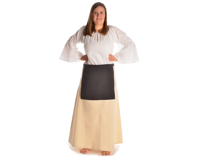 May include: A white peasant blouse with long sleeves and a black apron. The blouse has a gathered neckline and the apron has a simple rectangular shape.
