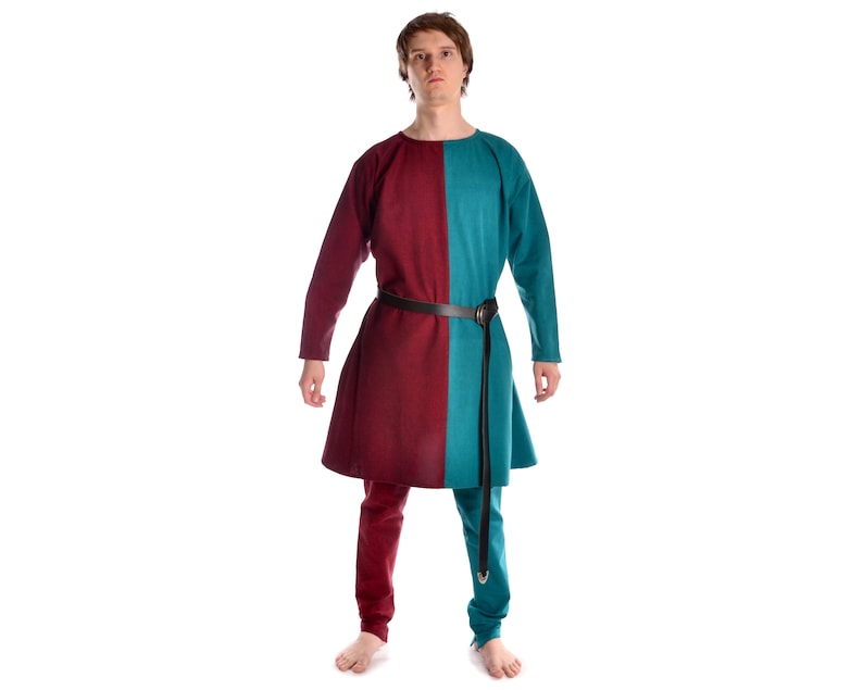 May include: A long-sleeved tunic with a burgundy and teal color block design. The tunic has a simple neckline and a belt at the waist.