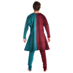 May include: A long tunic with a teal and burgundy color scheme. The tunic has a long, flowing shape and is made of a soft, comfortable fabric.