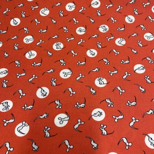 May include: Red fabric with a repeating pattern of white circles and gray mice. The mice are facing different directions and have long tails.
