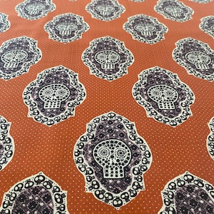 May include: A white ceramic mug with a black handle and the text "But First, Coffee" in a bold, black font. The mug is set against a blurred background, suggesting a cozy setting.