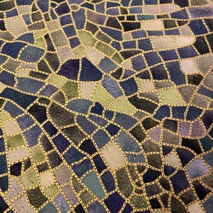 May include: Abstract fabric with a mosaic-like pattern. The design features irregular shapes in shades of blue, green, and gray, outlined with gold dotted lines. The overall effect is a textured, artistic design.