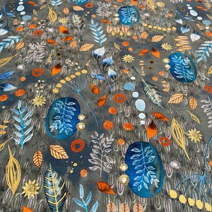 May include: A fabric with a dark gray background, featuring a repeating pattern of stylized leaves, flowers, and seed pods in shades of blue, orange, yellow, and white. The design has a watercolor-like effect.