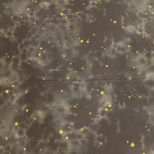 May include: Dark gray fabric with a tie-dye effect, featuring irregular gray patches and scattered yellow paint splatters. The fabric has a subtle texture and a seam running horizontally across the middle.