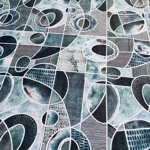May include: Abstract geometric pattern in shades of teal, gray, and black. The design features overlapping shapes, including circles, ovals, and rectangles, outlined in white. The pattern has a textured appearance with various line and dot details.