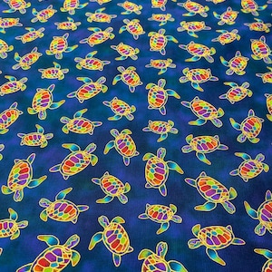 May include: Fabric with a repeating pattern of colorful sea turtles on a dark blue background. The turtles have vibrant rainbow-colored shells and yellow outlines. The fabric is suitable for various craft projects.