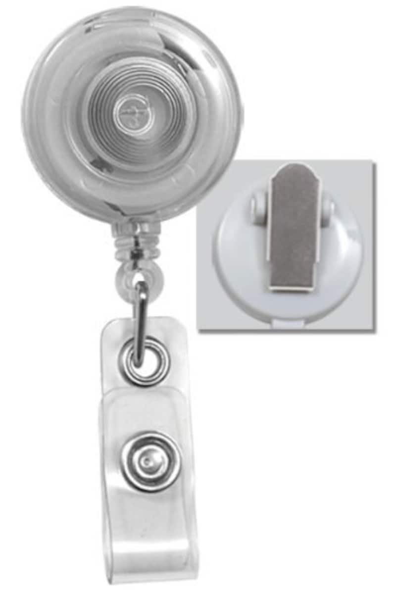 May include: A clear plastic retractable badge holder with a silver clip and a clear plastic strap. The badge holder has a spring-loaded mechanism that allows the strap to extend and retract.