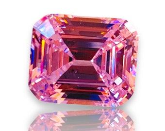May include: A pink emerald cut gemstone with a high polish and facets. The gemstone is reflecting light and has a slight purple hue.