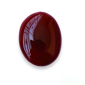 May include: A smooth, oval-shaped, red gemstone with a high gloss finish.
