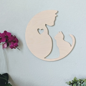 May include: Wooden wall decor featuring a silhouette of two cats, one larger than the other, with a heart shape in the larger cat's chest. The cats are facing each other and appear to be cuddling.
