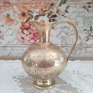 Chiseled brass pitcher with foliage decoration