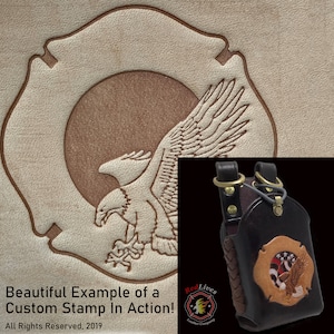 May include: A brown leather phone case with a tooled design of a fire department emblem with an eagle and American flag. The case has a braided strap and a brass buckle.