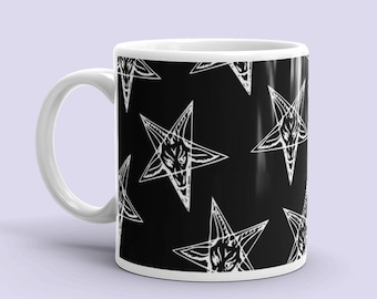 May include: White ceramic mug with a black background and a repeating pattern of white pentagrams with a goat's head inside each star.