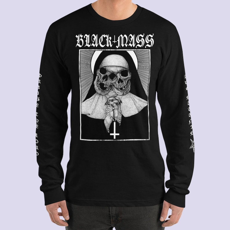 May include: Black long-sleeve t-shirt with a graphic print of a nun with a skull face. The text "BLACK MASS" is printed above the graphic. The sleeves have the text "BLACK MASS" printed vertically.