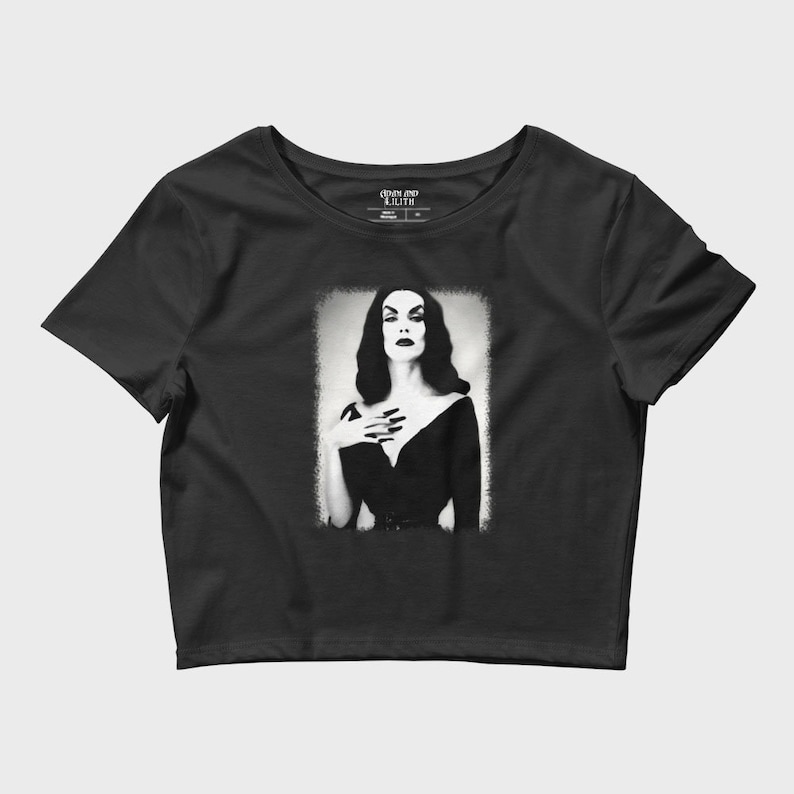 May include: Black cropped t-shirt with a graphic print of a woman in a black dress with a white background. The text "Coven and Lilith" is on the tag.