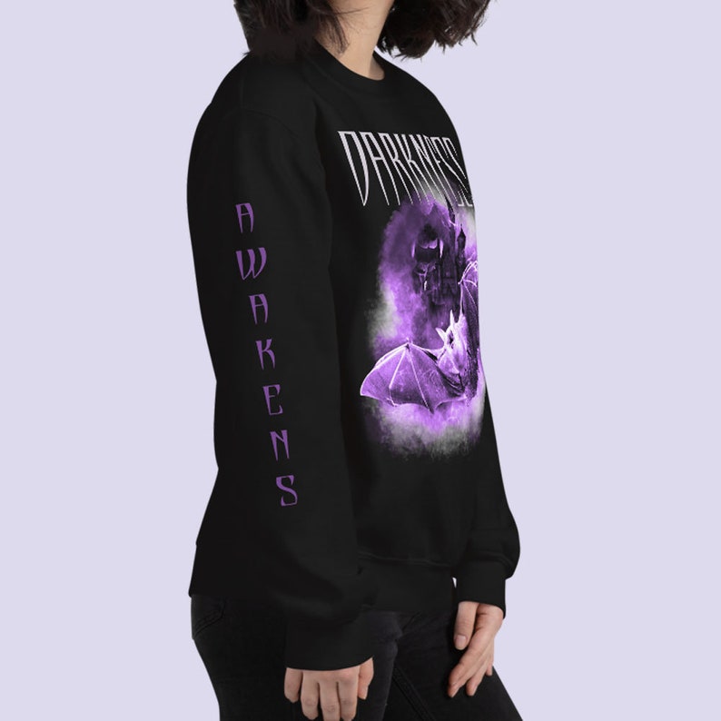 May include: Black long-sleeve sweatshirt with a purple graphic of a bat and the text "Darkness Awakens".