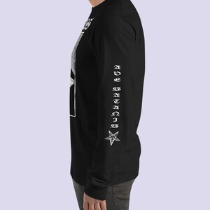 May include: Black long-sleeve shirt with a white graphic print of a pentagram and the text "Ave Satanas".