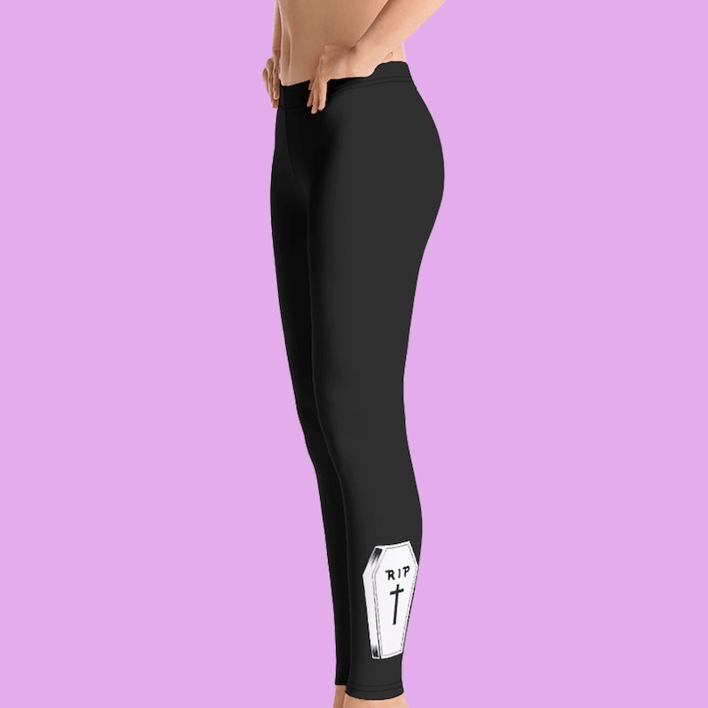 May include: Black leggings with a white coffin graphic that says "RIP" with a cross on it.