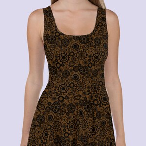 May include: A brown sleeveless dress with a black and brown gear pattern. The dress has a scoop neck and a fitted bodice.