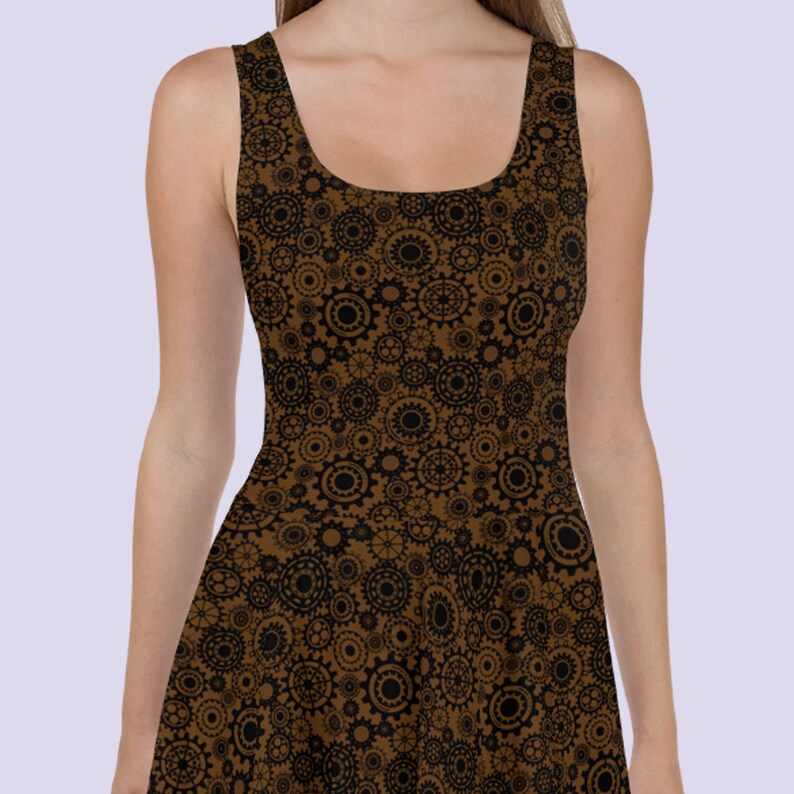 May include: A brown sleeveless dress with a black and brown gear pattern. The dress has a scoop neck and a fitted bodice.